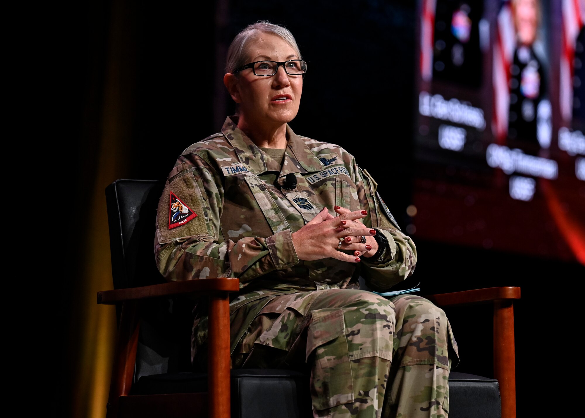 Female Space Force soldier speaks at a conference