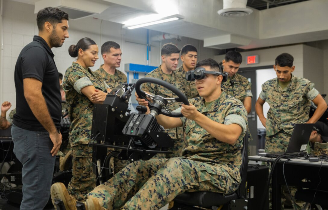 Marines use virtual reality to train on the ACV Driver Training System (DTS).