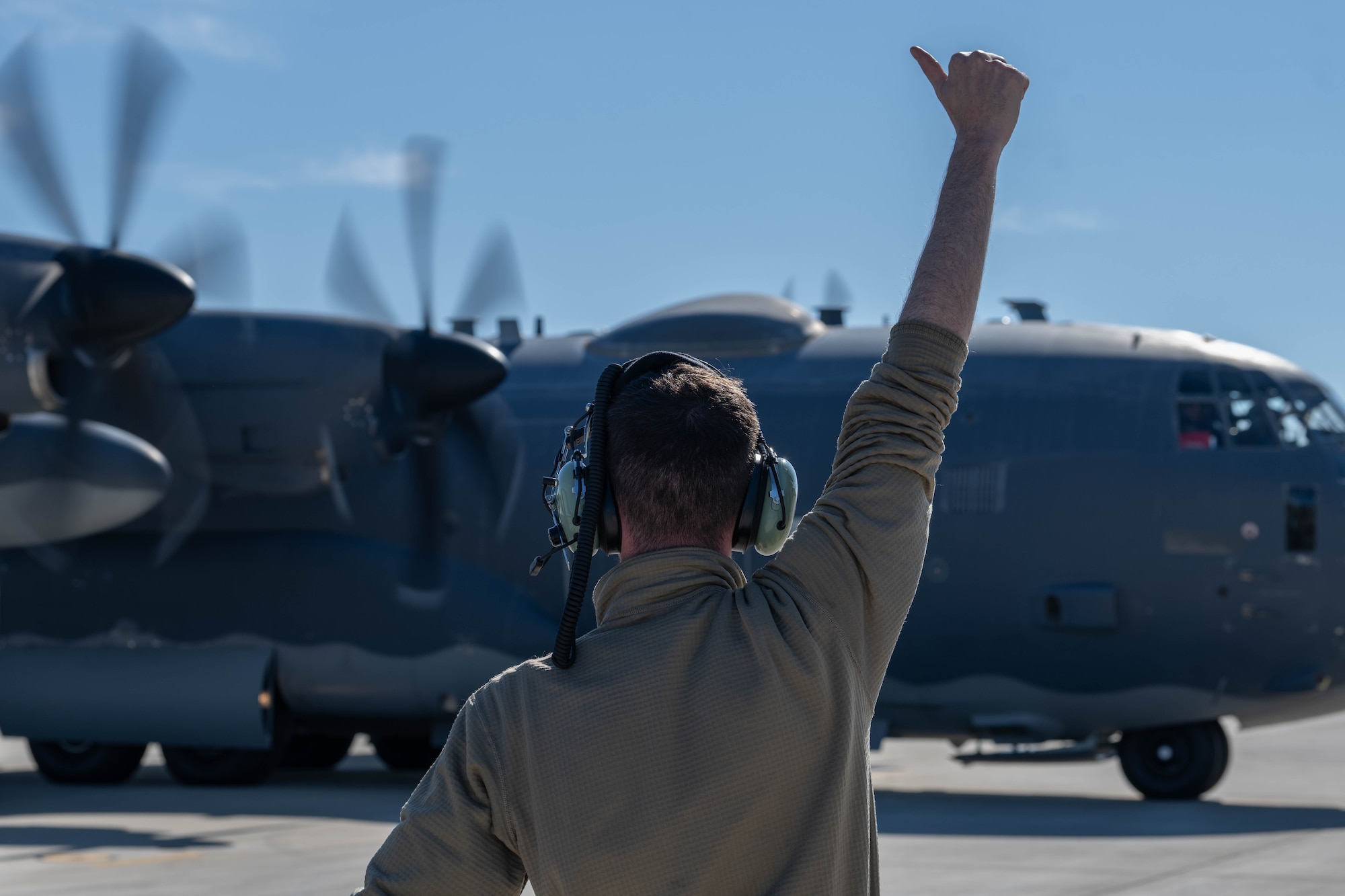 A 4th Special Operations Maintenance Squadron Airman directs a 4th Special Operations Squadron AC-130J Ghostrider gunship, as it prepares to taxi at Hurlburt Field, Florida, Dec. 4, 2024.
