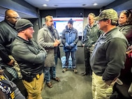 Director Omar Lopez meets with personnel in the NCIS Command Center at the 125th Army-Navy Game at Northwest Stadium in Landover, Maryland.