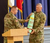 Matthew Serowka 1st Sgt. of Hotel Company, Recruit Sustainment Program presented Captain Clayton Riley, officer-in-charge of the Illinois National Guard Recruiting and Retention Battalion’s North Region a gift as Riley retired after 27 years of service.