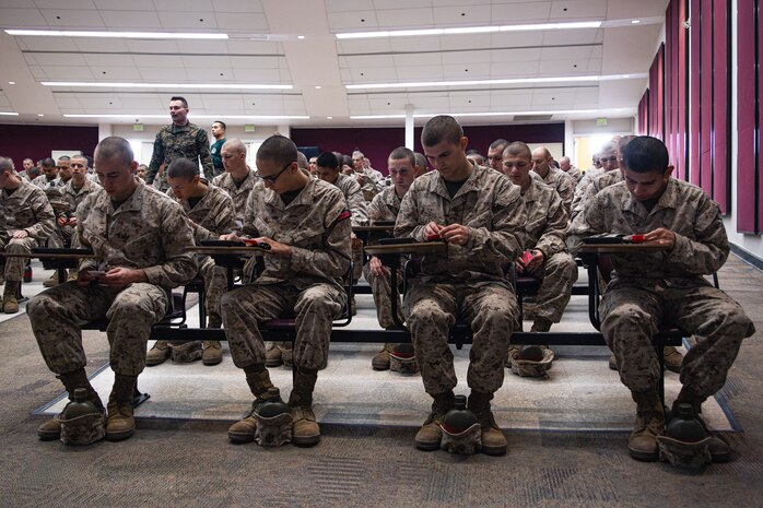 U.S. Marine Corps recruits with Bravo Company, 1st Recruit Training Battalion, conduct the written portion of exam one on tablets at Marine Corps Recruit Depot San Diego, California, Dec. 11, 2024. Following the knowledge exam, now taken on tablets in an effort to modernize the Marine Corps, recruits are evaluated on tactical combat casualty care, and how to disassemble and reassemble their M16A4 service rifles as taught throughout the duration of recruit training. Recruits have several opportunities to practice before exam one and the practical application test. (U.S. Marine Corps photo by Lance Cpl. Eric Valerio)