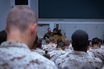 U.S. Marine Corps Staff Sgt. Hunter Rippey, a drill instructor with Support Battalion, Recruit Training Regiment, gives instructions to recruits during their written portion of exam one at Marine Corps Recruit Depot San Diego, California, Dec. 11, 2024. Following the knowledge exam, now taken on tablets in an effort to modernize the Marine Corps, recruits are evaluated on tactical combat casualty care, and how to disassemble and reassemble their M16A4 service rifles as taught throughout the duration of recruit training. Recruits have several opportunities to practice before exam one and the practical application test. (U.S. Marine Corps photo by Lance Cpl. Eric Valerio)