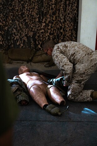 U.S. Marine Corps Recruit Jesse Camarena with Bravo Company, 1st Recruit Training Battalion,  bandages a simulated wound during a combat care exam at Marine Corps Recruit Depot San Diego, California, Dec. 11, 2024.Following the knowledge exam, now taken on tablets in an effort to modernize the Marine Corps, recruits are evaluated on tactical combat casualty care, and how to disassemble and reassemble their M16A4 service rifles as taught throughout the duration of recruit training. Recruits have several opportunities to practice before exam one and the practical application test. (U.S. Marine Corps photo by Lance Cpl. Eric Valerio)