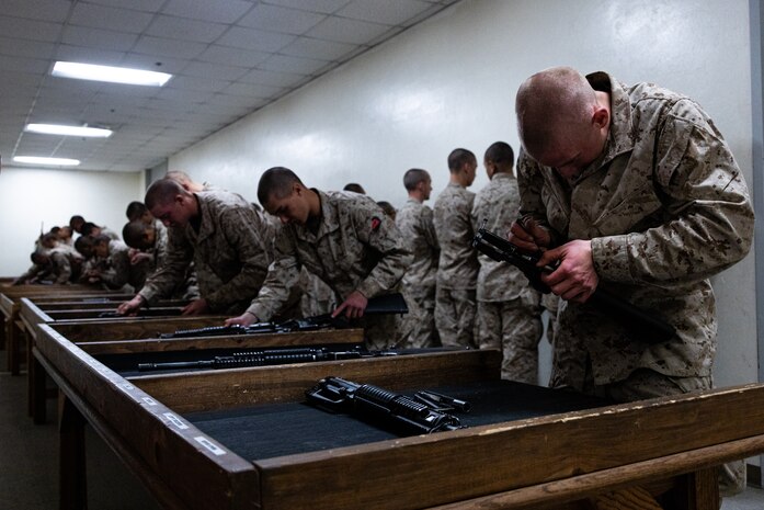 U.S. Marine Corps recruits with Bravo Company, 1st Recruit Training Battalion, reassemble M16-A4 service rifles during a practical application exam at Marine Corps Recruit Depot San Diego, California, Dec. 11, 2024. Following the knowledge exam, now taken on tablets in an effort to modernize the Marine Corps, recruits are evaluated on tactical combat casualty care, and how to disassemble and reassemble their M16A4 service rifles as taught throughout the duration of recruit training. Recruits have several opportunities to practice before exam one and the practical application test. (U.S. Marine Corps photo by Lance Cpl. Eric Valerio)