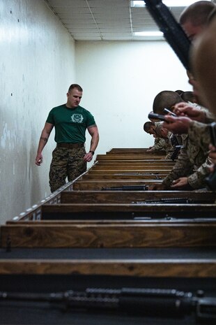 U.S. Marine Corps Sgt. Tristan Taylor, a drill instructor with Support Battalion, Recruit Training Regiment, inspects recruits during a practical application exam at Marine Corps Recruit Depot San Diego, California, Dec. 11, 2024. Following the knowledge exam, now taken on tablets in an effort to modernize the Marine Corps, recruits are evaluated on tactical combat casualty care, and how to disassemble and reassemble their M16A4 service rifles as taught throughout the duration of recruit training. Recruits have several opportunities to practice before exam one and the practical application test. (U.S. Marine Corps photo by Lance Cpl. Eric Valerio)