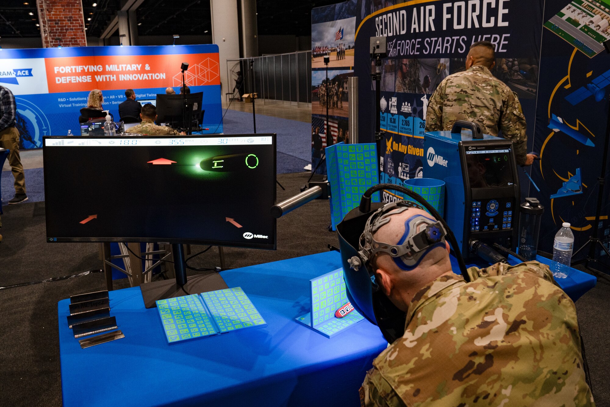 A man use a virtual reality welding simulator that projects what he sees on a computer monitor
