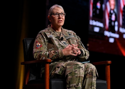Female Space Force soldier speaks at a conference