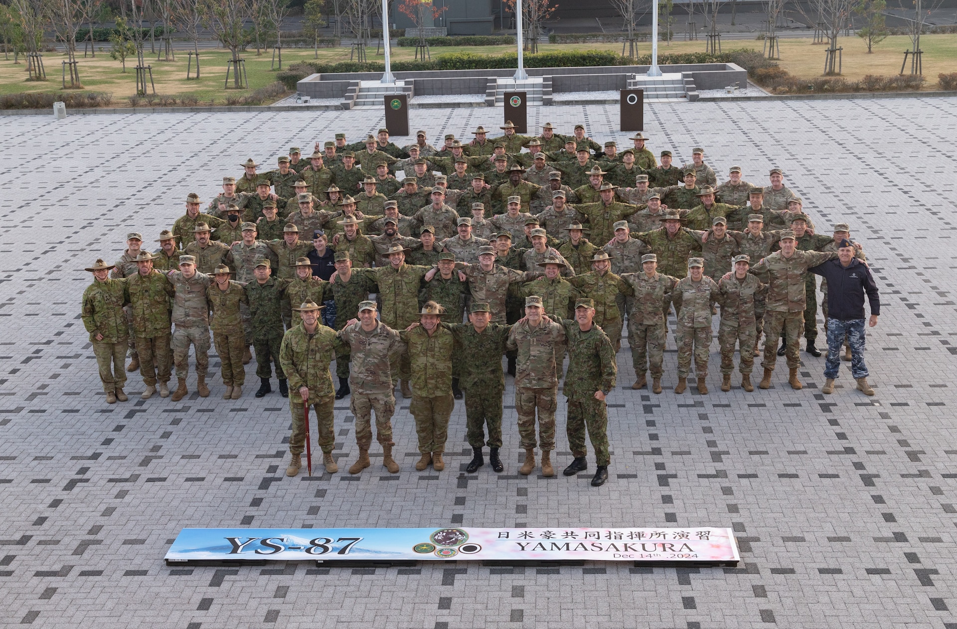 Service members from the U.S. Army's Pacific, America's First Corps, Japan Ground Self-Defense Force and the Australian Defence Force celebrate the conclusion of Yama Sakura 87 at Camp Asaka, Japan, Dec. 14, 2024.