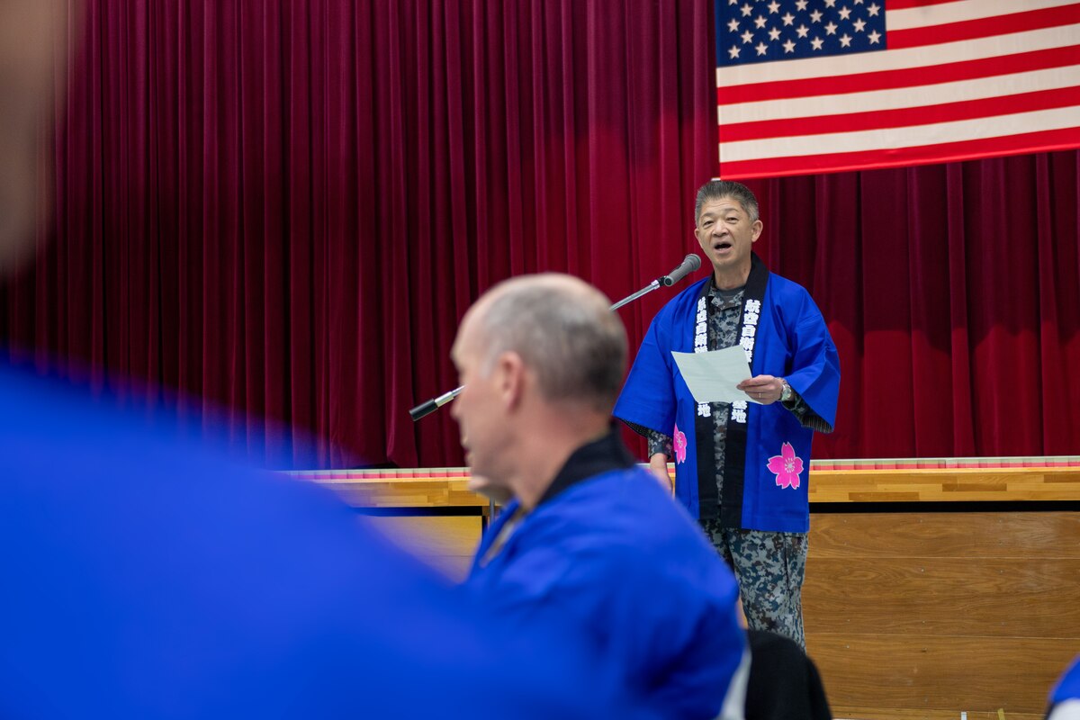 A Japan Air Self-Defense Force Col. speaks while wearing a blue Japanese traditional blouse.