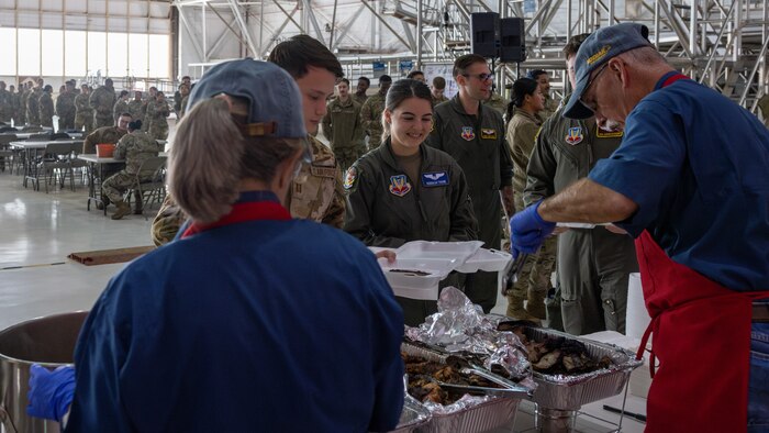 Military members standing in line for BBQ