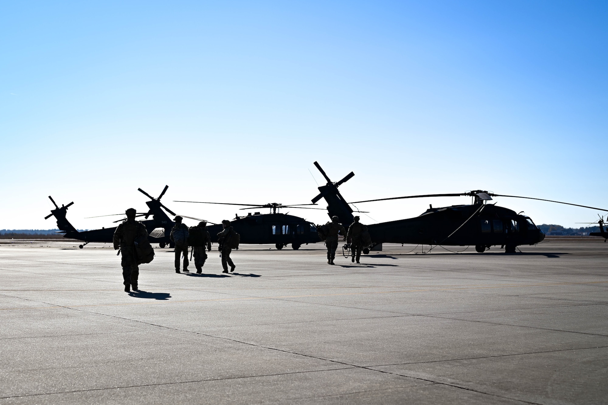 Airmen approach aircraft on the flightline.