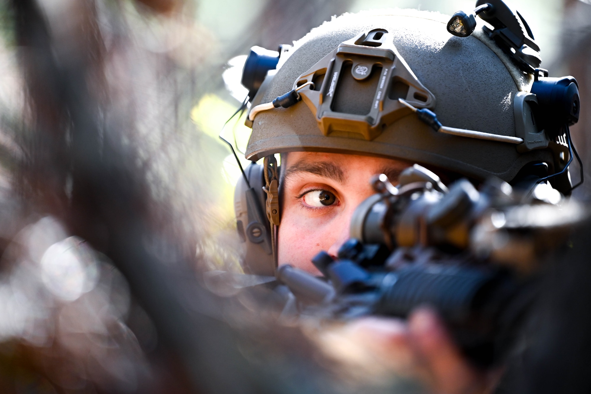 An Airman aims his rifle from a defensive fighting position.