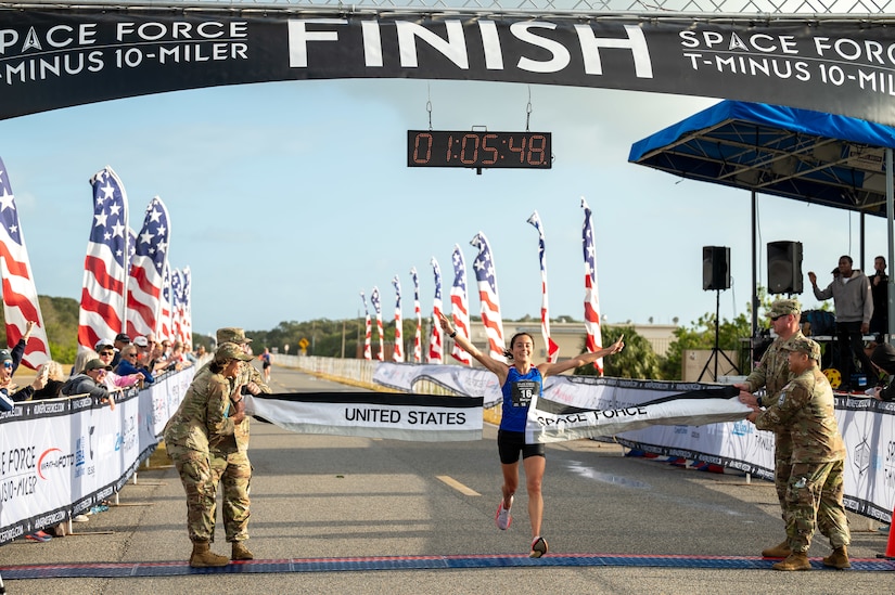 Female runner crossing the finish line.