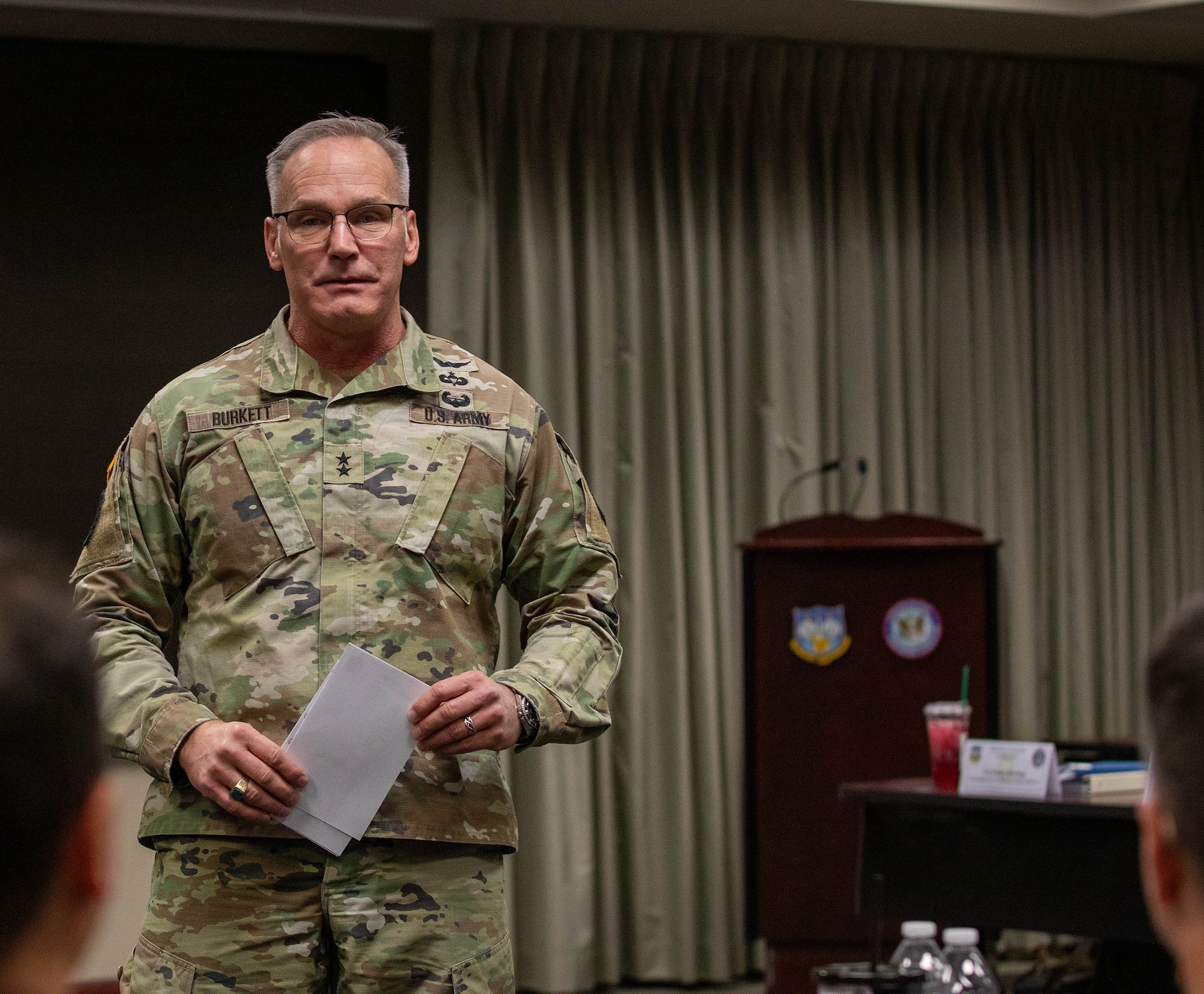 Army Maj. Gen. Ronald Burkett, director of Domestic Operations and Force Development at the National Guard Bureau, addresses nearly nearly 30 officers at the O-6 level and above, from 50 states, three territories, and the District of Columbia, and active-duty components from across the country during the Dual Status Command Training Course, at the North American Aerospace Defense Command and U.S. Northern Command headquarters on Peterson Space Force Base, Colo., Dec. 13, 2024.