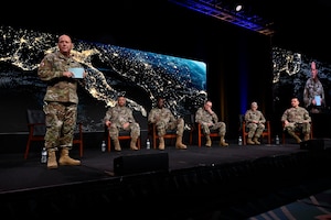 Space Force leaders speak at a conference on stage.