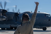 A 4th Special Operations Maintenance Squadron Airman directs a 4th Special Operations Squadron AC-130J Ghostrider gunship, as it prepares to taxi at Hurlburt Field, Florida, Dec. 4, 2024.