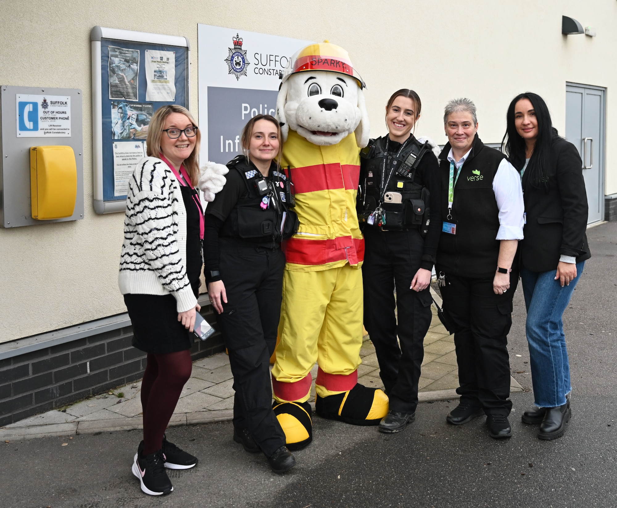 Sparky the Fire Dog from the 100th Air Refueling Wing, Royal Air Force Mildenhall, visits police officers and civilians at the local Suffolk Constabulary while out and about in Mildenhall, England, Dec. 13, 2024. The 100th Civil Engineer Squadron Fire Department mascot also stopped by to say hello to children at Little Treasures Pre-School, Mildenhall. (U.S. Air Force photo by Karen Abeyasekere)