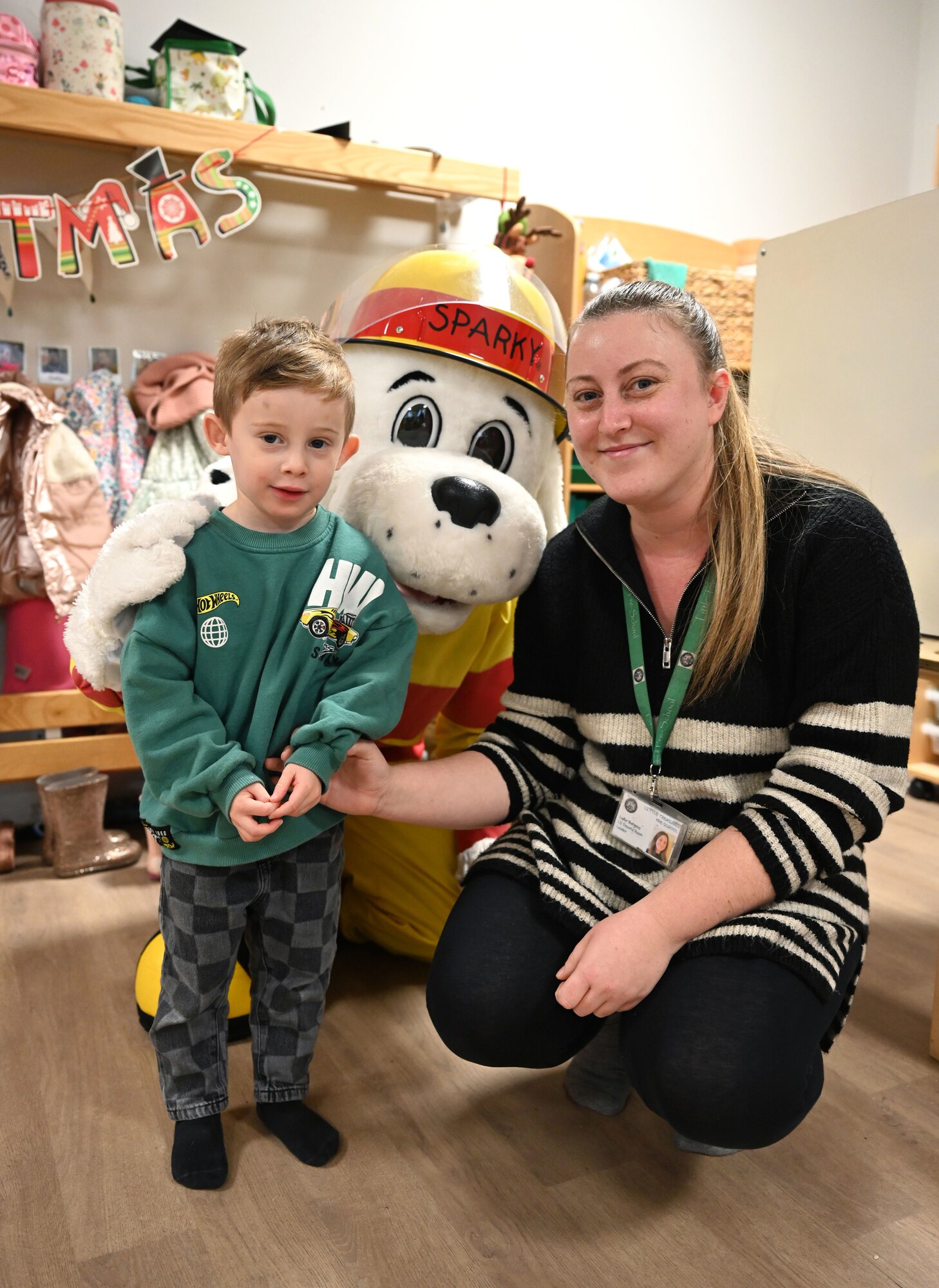 Sparky the Fire Dog from the 100th Air Refueling Wing, Royal Air Force Mildenhall, visits staff and children at Little Treasures Pre-School in Mildenhall, England, Dec. 13, 2024. The 100th Civil Engineer Squadron Fire Department mascot also stopped by to say hello to members of the local Suffolk Constabulary at the nearby police station while he was out and about in the local community. (U.S. Air Force photo by Karen Abeyasekere)