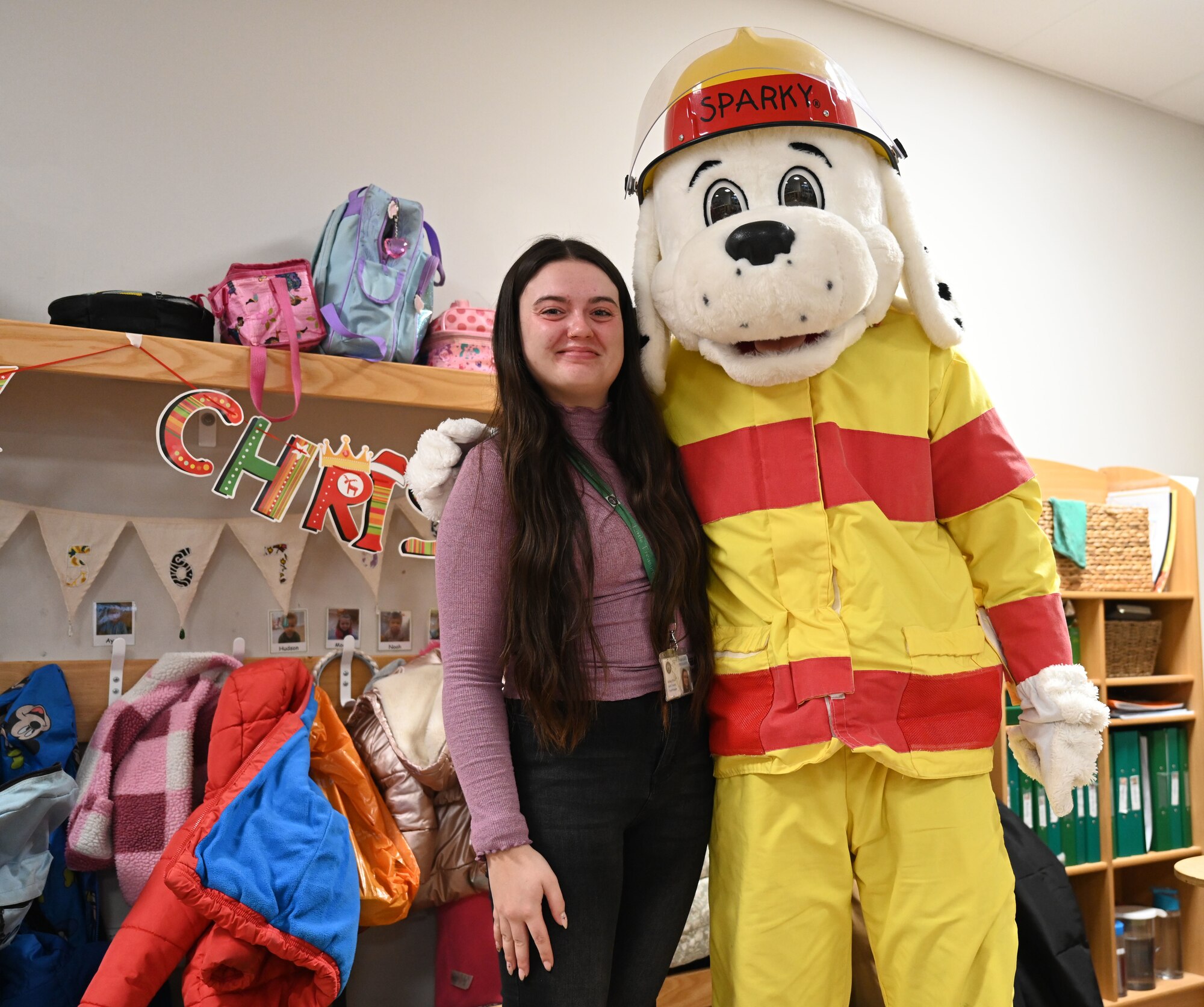 Sparky the Fire Dog from the 100th Air Refueling Wing, Royal Air Force Mildenhall, visits staff and children at Little Treasures Pre-School in Mildenhall, England, Dec. 13, 2024. The 100th Civil Engineer Squadron Fire Department mascot also stopped by to say hello to members of the local Suffolk Constabulary at the nearby police station while he was out and about in the local community. (U.S. Air Force photo by Karen Abeyasekere)
