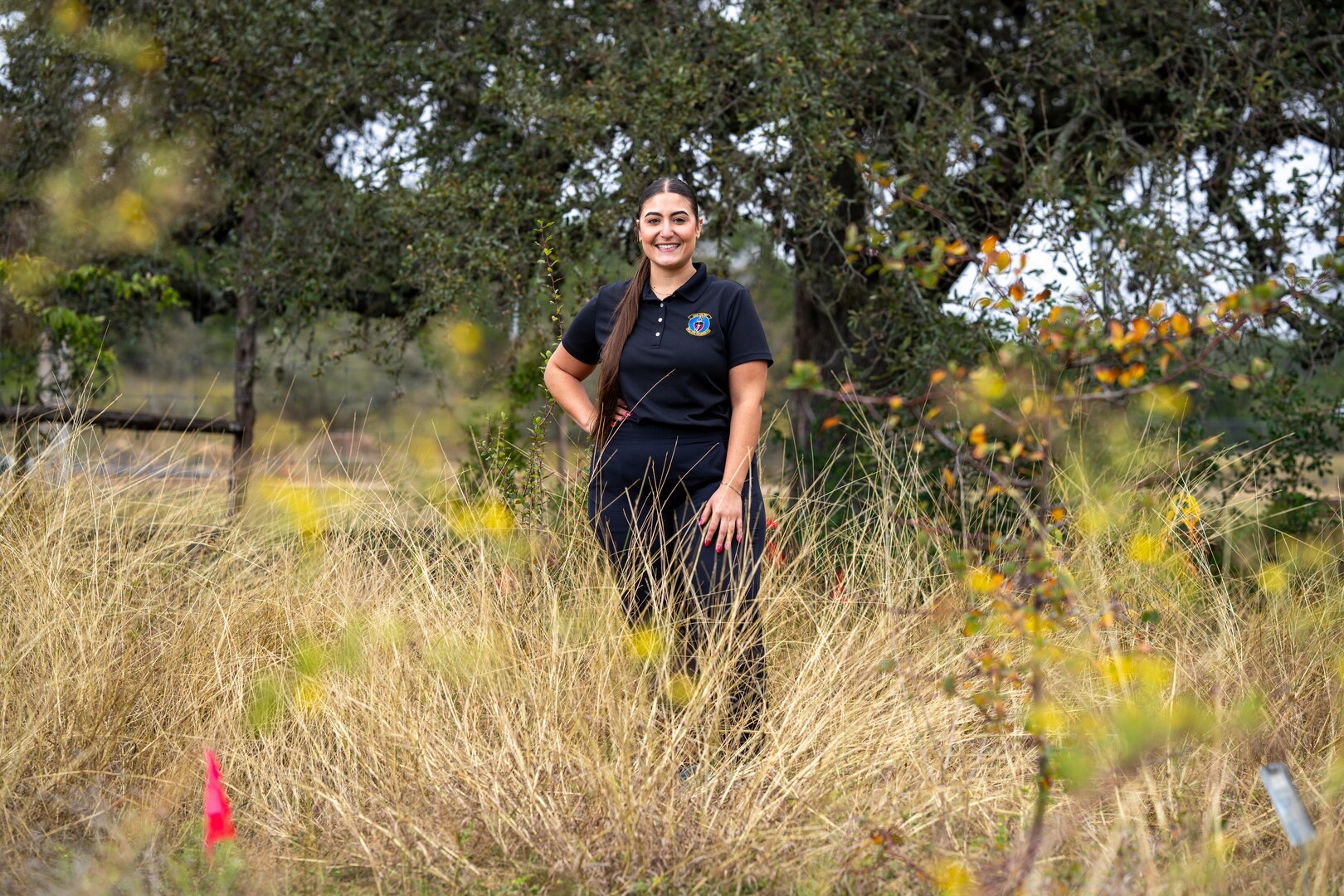 female standing in high grass