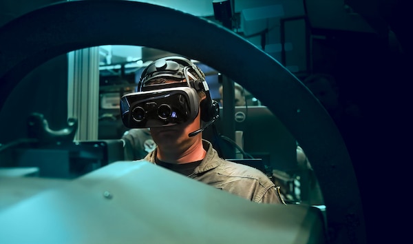 Capt. Juston Kuch, Training Air Wing One Commodore, operates a simulated T-45 Goshawk in the Operational Flight Trainer onboard NAS Meridian. The simulators incorporate augmented-reality technology to enhance student pilot training.