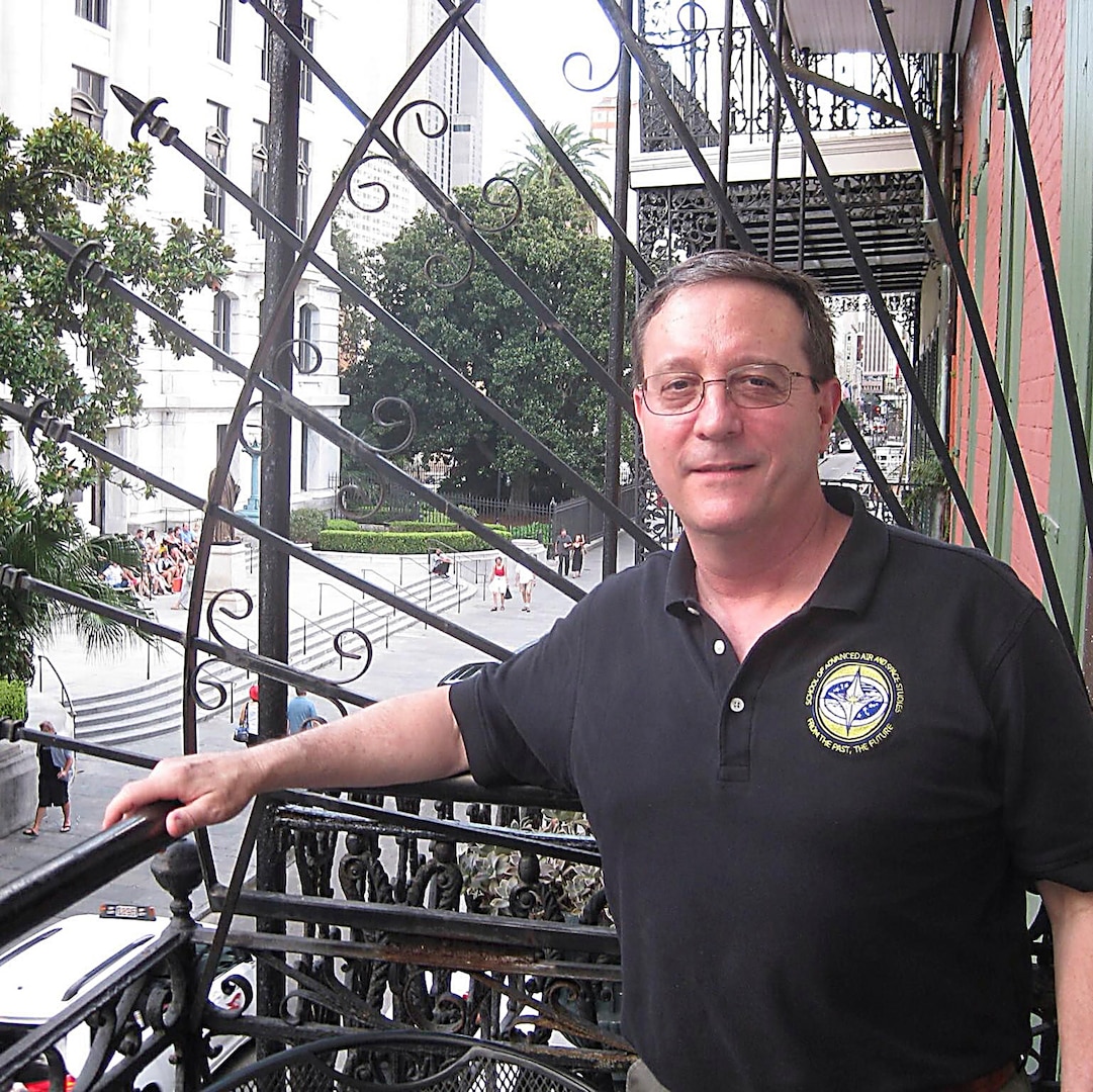 male posing for a photo on a balcony