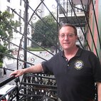 male posing for a photo on a balcony