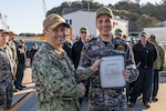 Rear Adm. Chris Cavanaugh, commander, Submarine Group 7, and Royal Australian Navy Lt. Cmdr. James pose for a photo during pier-side quarters for the Virginia-class fast-attack submarine USS Vermont (SSN 792) at Commander, Fleet Activities Yokosuka, Dec. 12.