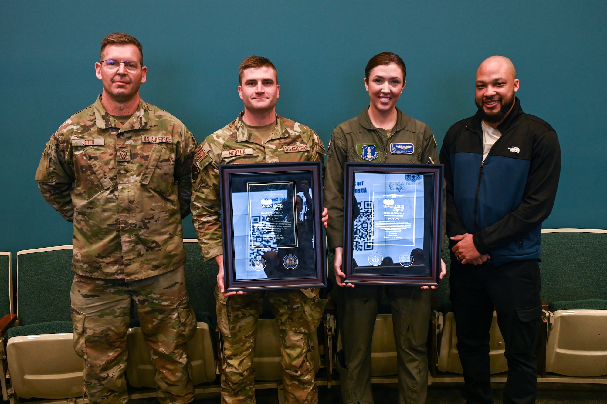 Four Airmen pose following an award ceremony.