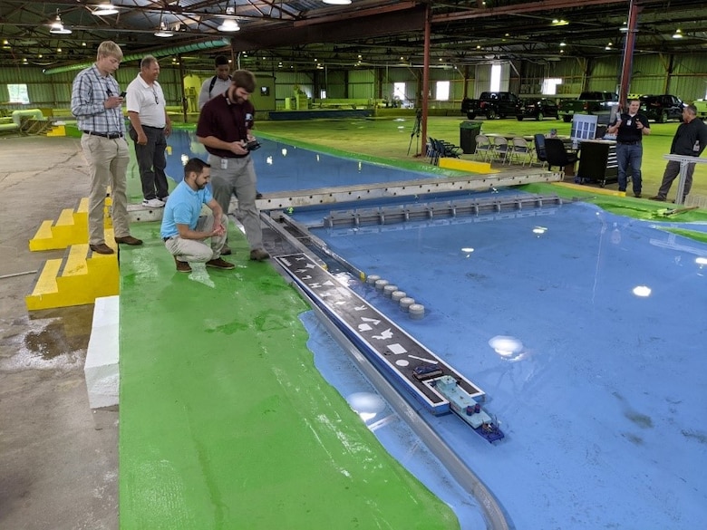 Hydraulic Engineer Ryan Hoben is demonstrating the navigation of a scale model tow into the Emsworth 1:100 scale navigation model.