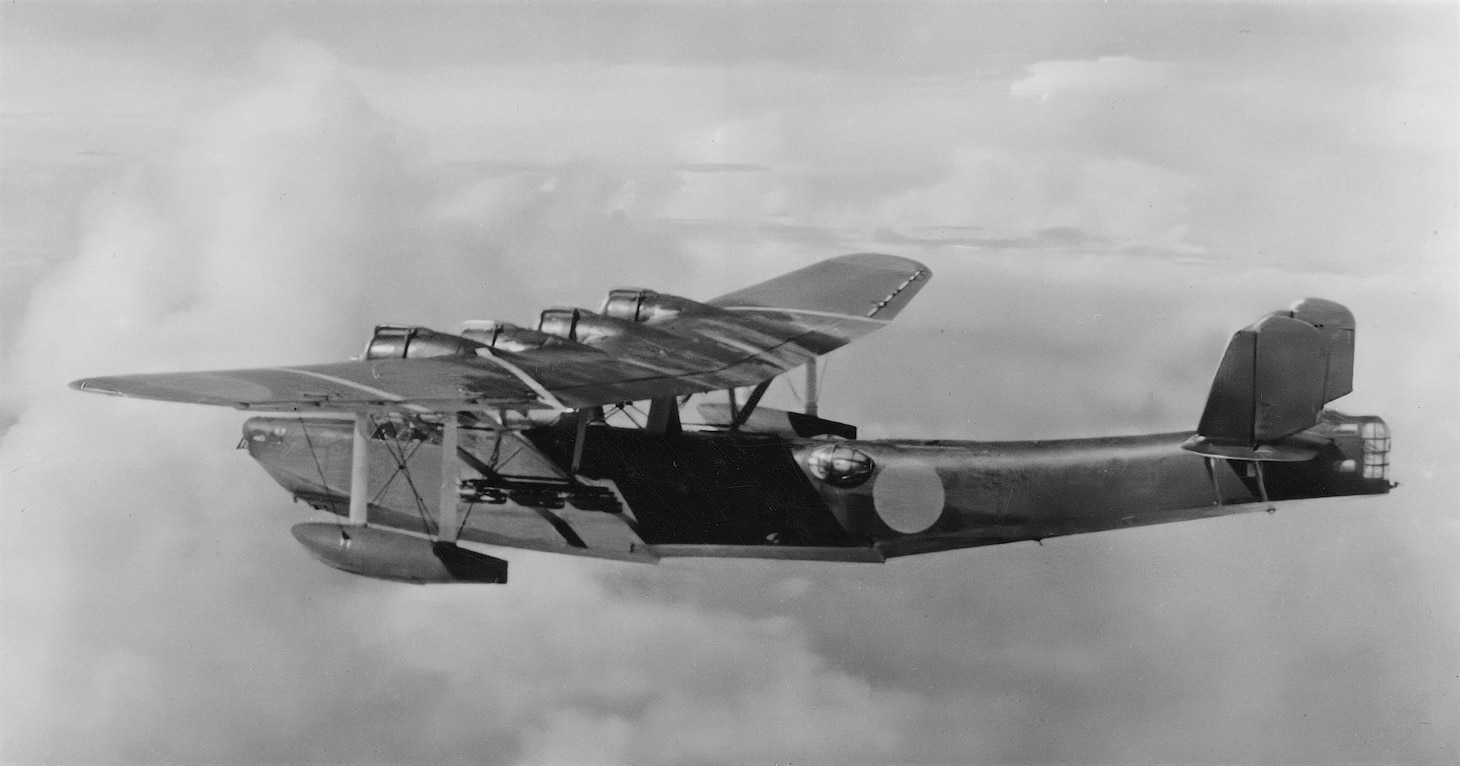 This H6K Type 97 Mavis is carrying perhaps 12 small 132-pound bombs on underwing struts. Besides its maritime patrol duties, the Mavis was occasionally used as a bomber. Using four 1300 hp radial engines, it originally had a power-operated dorsally-mounted turret, which was replaced by two staggered (one on each side) blisters—similar to the U.S. PBY Catalina—each containing a 7.7mm  machine gun. A third 7.7mm machine gun was placed in the bow station, while a fourth machine gun could be mounted in an open station just aft of the two blisters. In addition, the Mavis also used a 20mm cannon in a hand-operated tail turret.