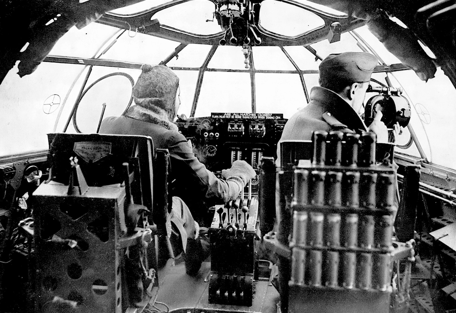 The Sunderland was a large aircraft, even for a flying boat, and accommodations on such aircraft are not always that great. But as viewed here, the Sunderland’s cockpit flight station was quite roomy. The Royal Air Force captain on the left has his hand on the four throttles while the co-pilot signals a convoy below with an Aldis lamp. Large “boats” usually included extra pilots in their crews because of the duration of their over-water missions.