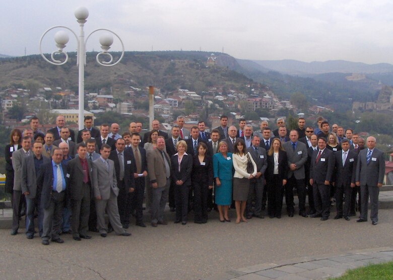 A large group of people gather for a photo in Tbilisi, Georgia.