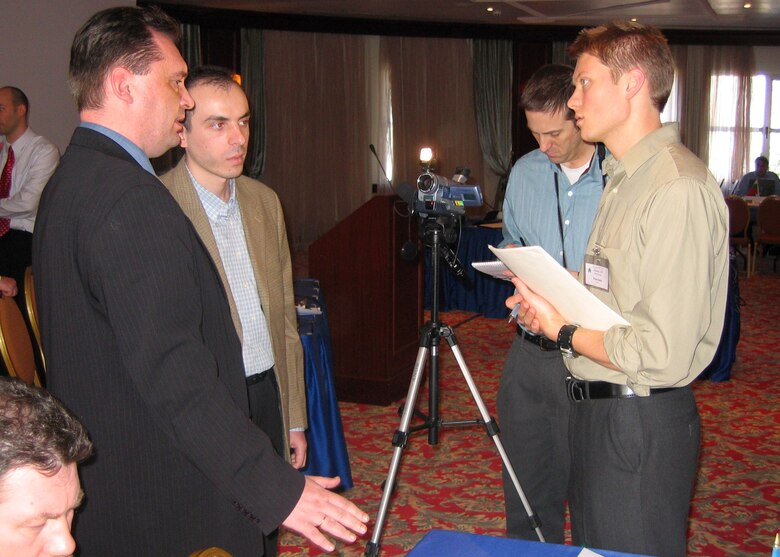 Two men interview two other men.