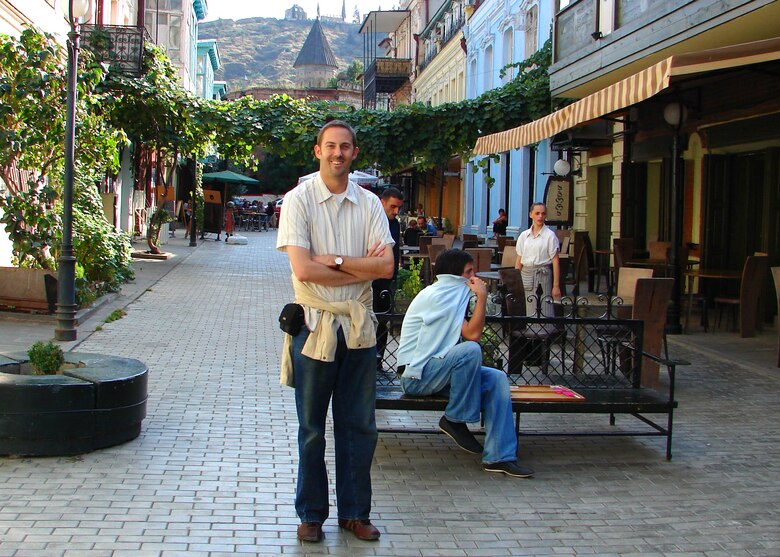 A man poses for a picture in the old town section of Tbilisi, Georgia.