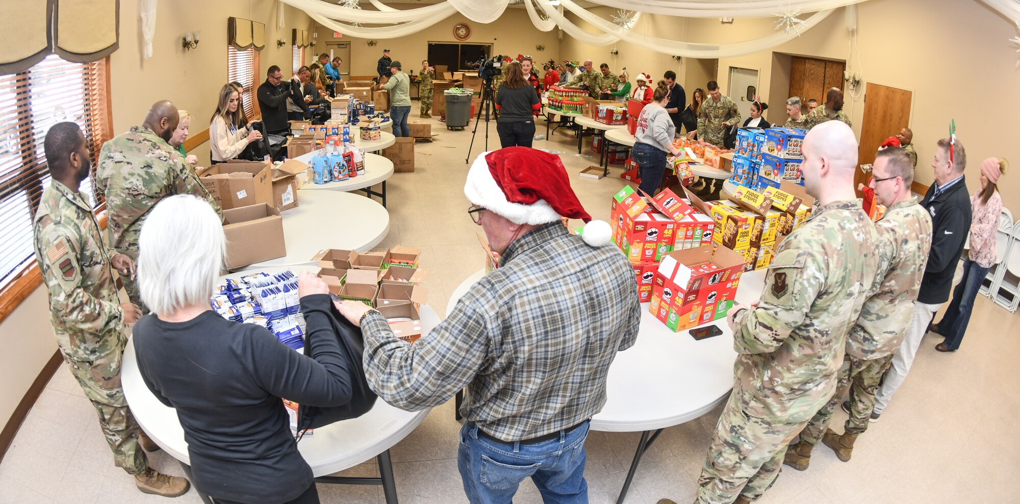 Offutt Air Force Base Airmen and local community leaders pack gift bags for dormitory residents at the Bellevue Volunteer Fire Department on Dec. 11, 2024. Operation Holiday Cheer brought over 40 local community leaders and Offutt Airmen together to pack 480 gift bags for dormitory residents. (U.S. Air Force photo by Chad Watkins)