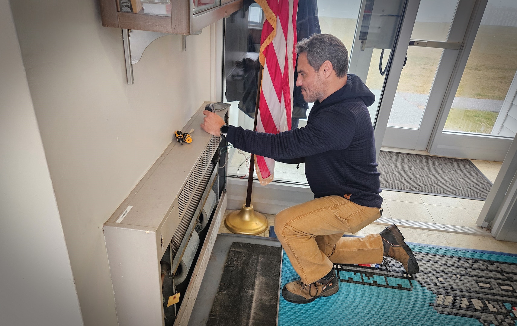 Keeper James Dietrich does maintenance on a fan coil unit at Station Jonesport on Dec. 11, 2024. Dietrich is part of Op Bench Strength, a pilot in District 1 that is using civilian station keepers to maintain and repair Coast Guard facilities so crews can focus on training and operating boats on the water. (U.S. Coast Guard photo by MKC Jeremiah Ward)