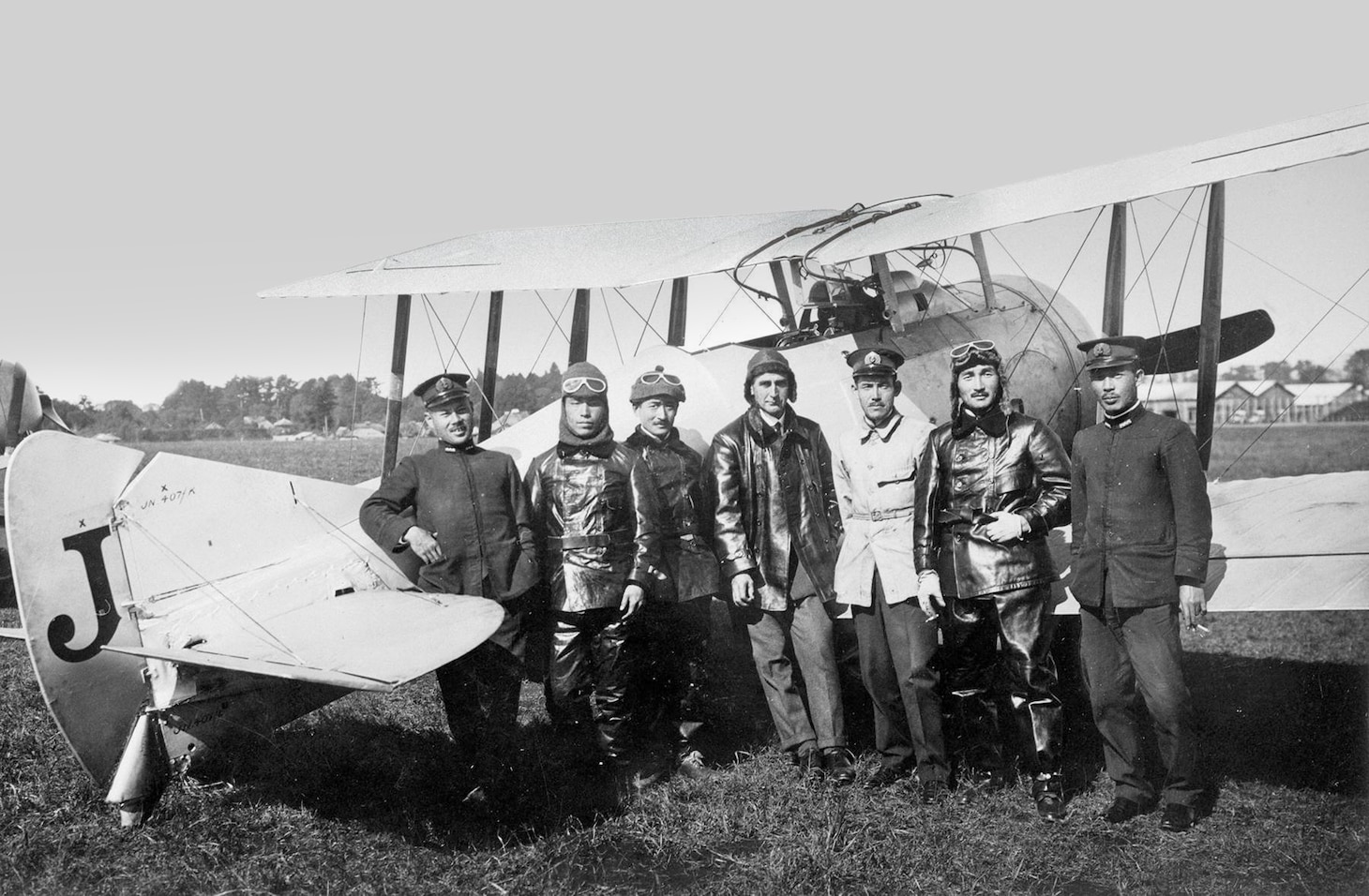 A Sempill Mission British flying instructor stands with Japanese naval aviators in front of a Gloster Sparrowhawk I. As part of the mission, 50 of the carrier fighters were supplied to the Japanese Navy in 1921