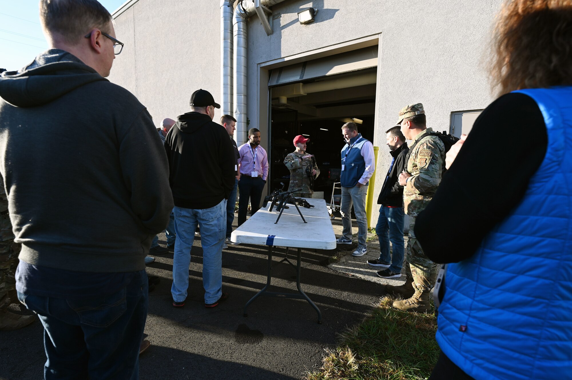 U.S. Air Force Staff Sgt. Jarod Chaidez, 445th Security Forces Squadron combat arms instructor, shows civilian employees of Citizen Airmen some of the weapons SFS utilizes for their mission during Employers Day at Wright-Patterson Air Force Base, Nov. 2, 2024. The 445th SFS was one of many mission sets employees were shown to showcase the wing and Air Force Reserve. (U.S. Air Force photo by Amanda Dick)