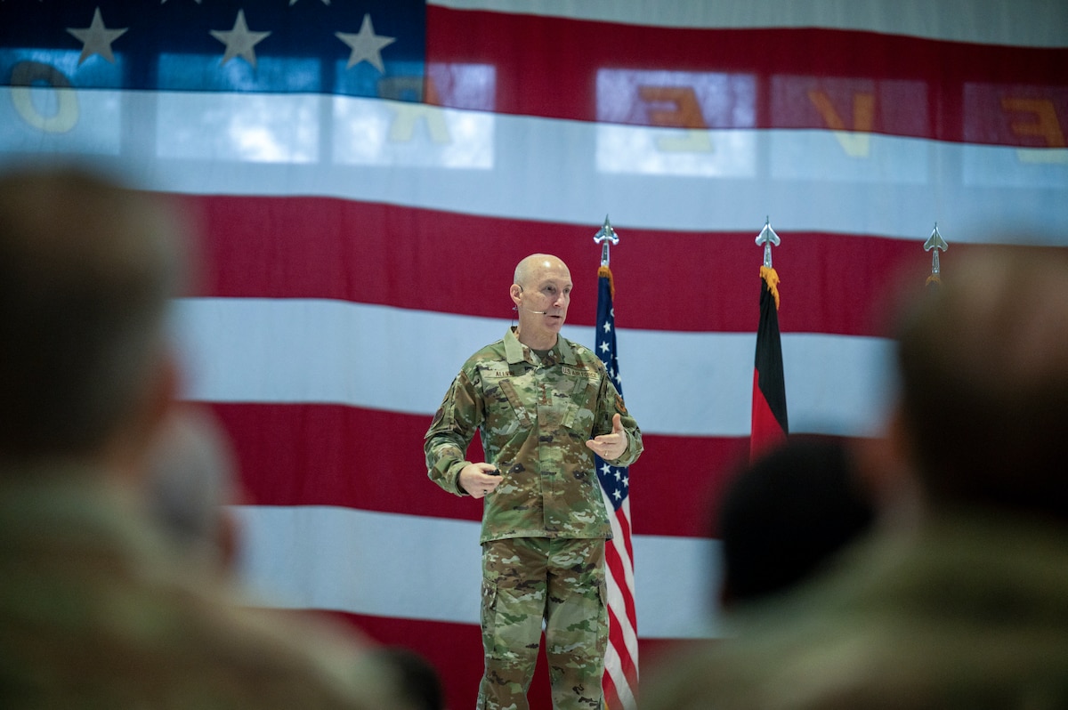 Military leadership briefs a crowd.