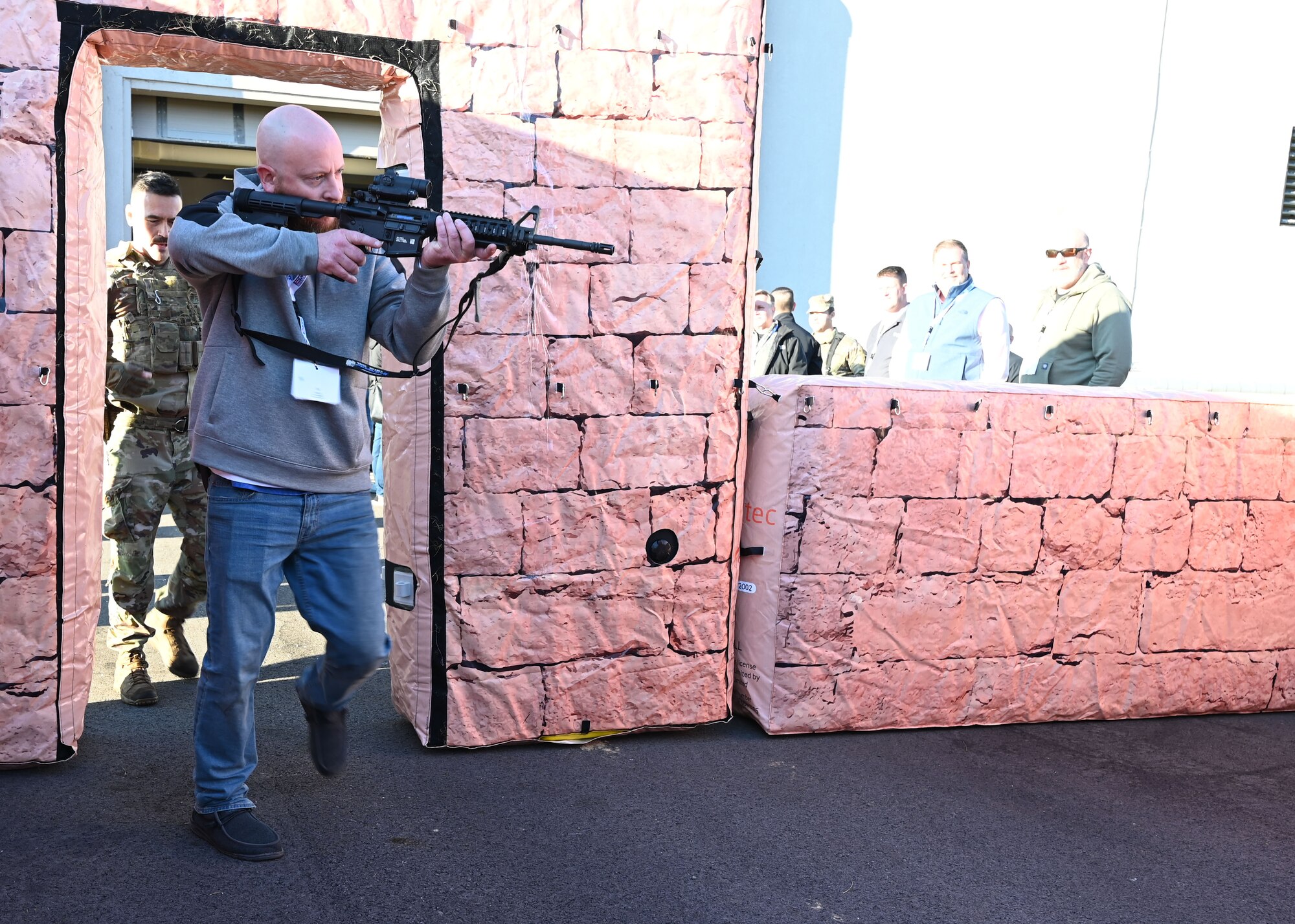RJ Riehle, employer of U.S. Air Force Senior Master Sgt. Eric Riehle with the 445th Aeromedical Evacuation Squadron, and U.S. Air Force Tech. Sgt. Joel Ford, 445th Security Forces Squadron fire team leader, breach a door in a simulated urban environment during Employers Day at Wright-Patterson Air Force Base, Nov. 2, 2024. Civilian employees of Citizen Airmen were able to practice securing a building after being instructed by 445th SFS Airmen on proper maneuvers. (U.S. Air Force photo by Amanda Dick)