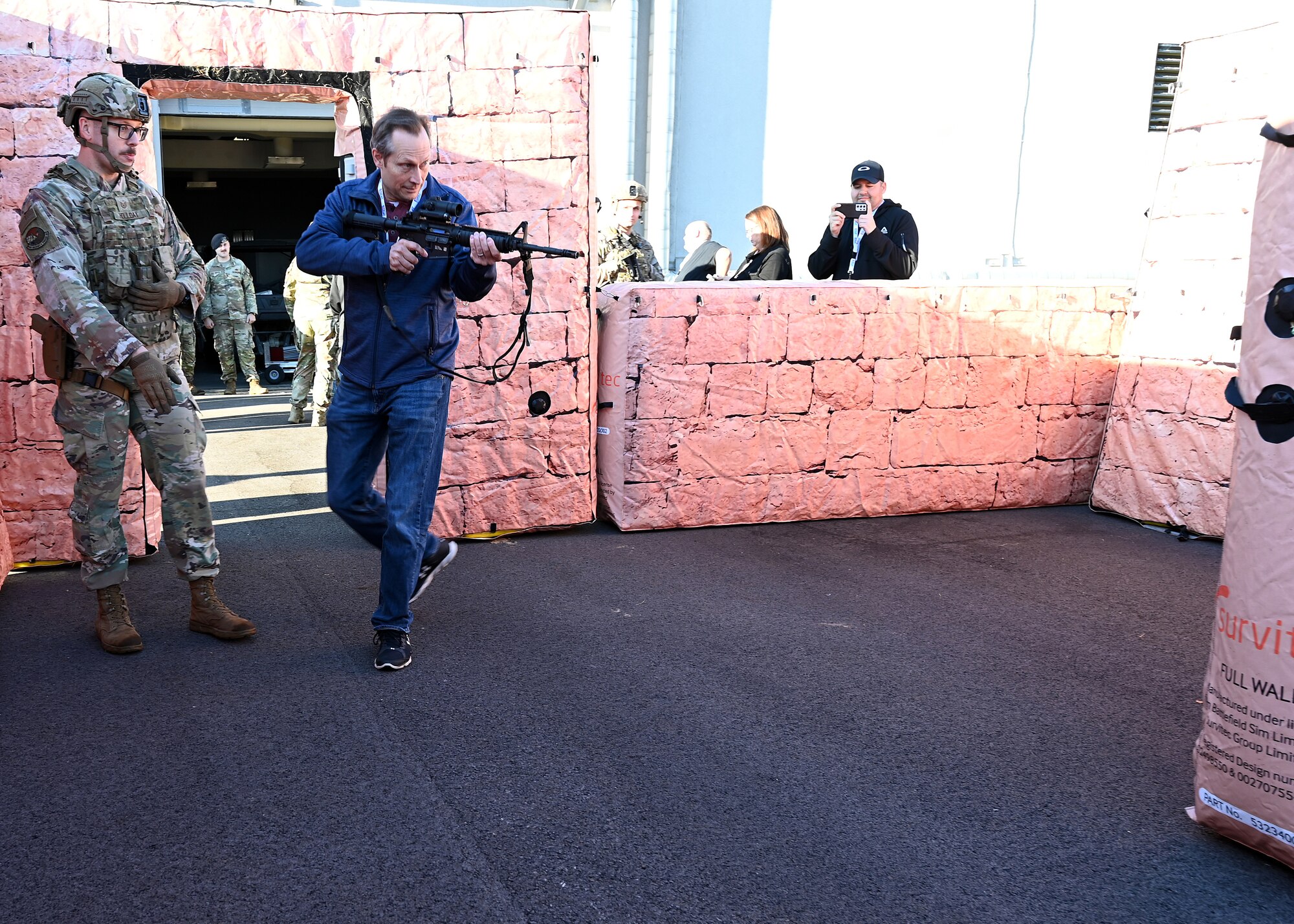 Brian Vacha, employer of U.S. Air Force Capt. Caleb Smith with the 445th Operations Support Squadron, secures a building in a simulated urban environment during Employers Day at Wright-Patterson Air Force Base, Nov. 2, 2024. Civilian employees of Citizen Airmen were able to practice securing a building after being instructed by 445th Security Forces Airman Airmen on proper maneuvers. (U.S. Air Force photo by Amanda Dick)