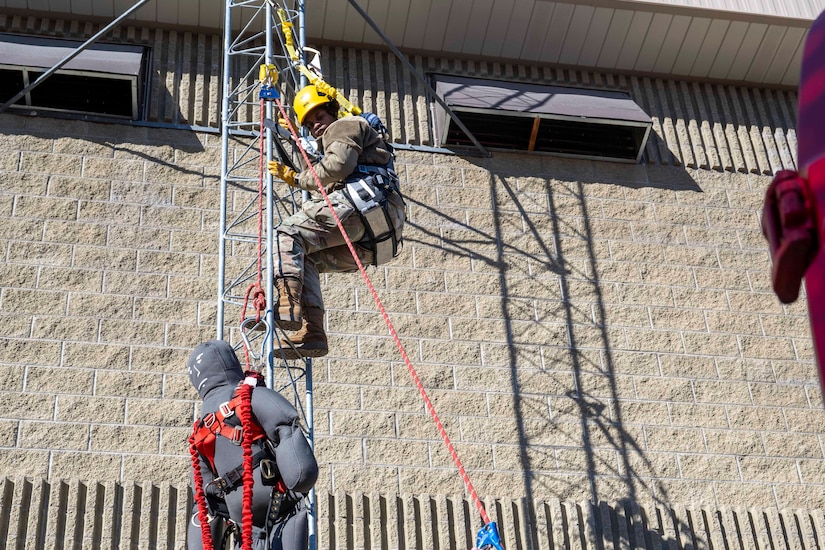 A guardsman climbs a tower.