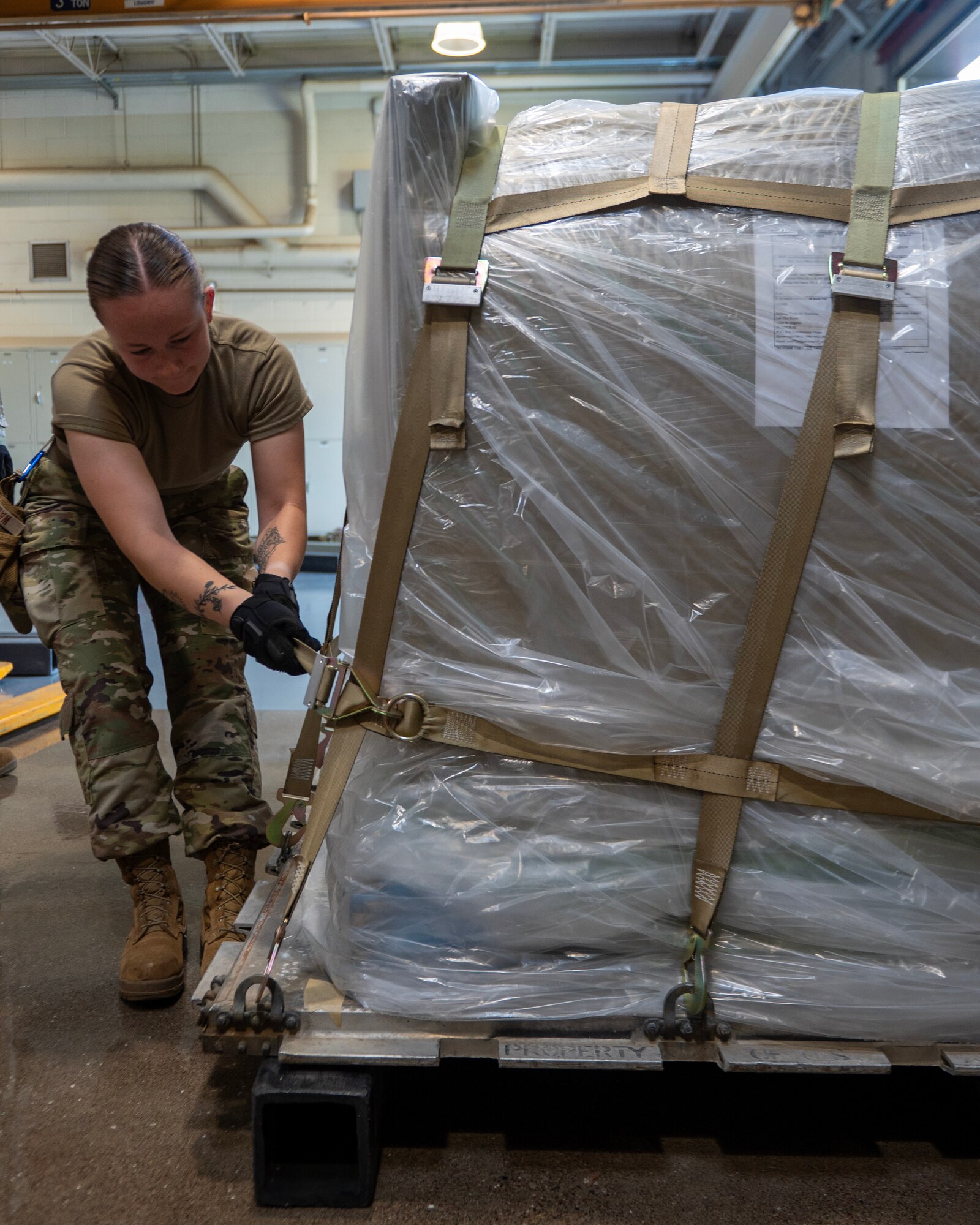 U.S. Air Force Airman First Class Jordan Walsh tightens the cargo strap in St. Paul, Minn., Sept. 3, 2024.