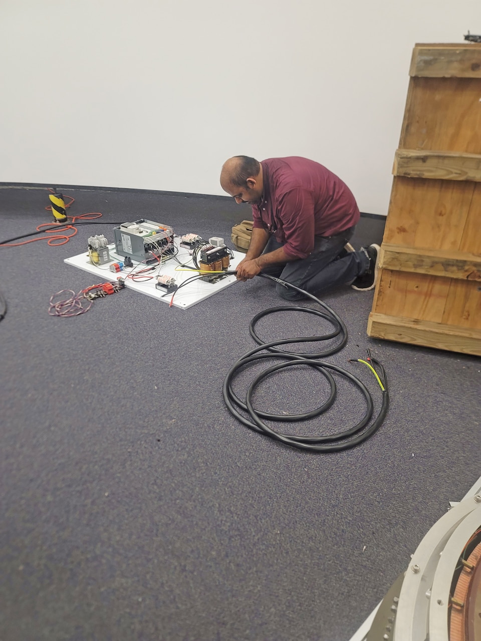 Anil Thomas, a mechanical engineer with NAWCTSD who designed the motor control unit works on the prototype motor control unit for the Multi-Station Disorientation Demonstrator, or the “spin and puke” trainer.