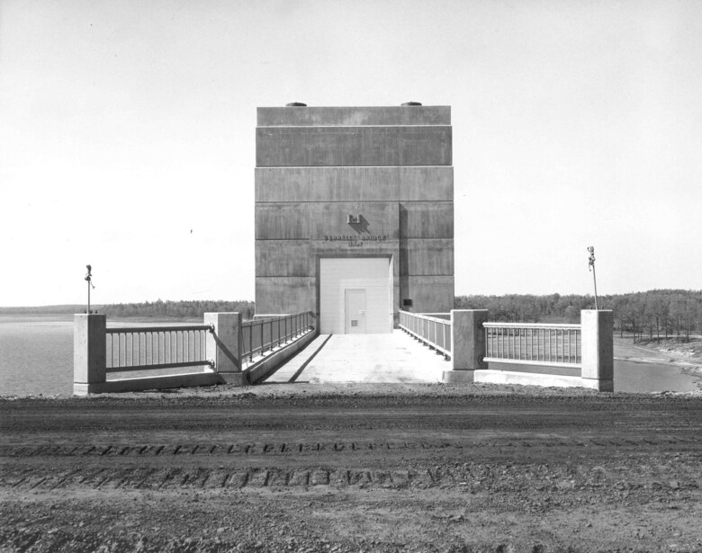 A view of the control structure, during construction of the lake, from the future roadway at Lake O’ the Pines. The outlet works has two gates that control the amount of water that is discharged from the lake. The discharge controls the level of the lake while providing proper flow to the river below the dam. The lake’s mission is to provide water to the Northeast Texas Municipal Water District and flood risk mitigation to communities along the Red River.