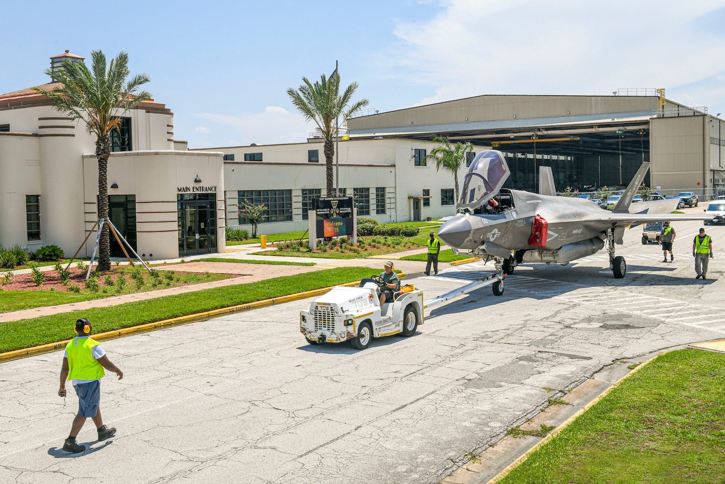 JACKSONVILLE, Fla. (Aug. 08, 2024) Personnel from Fleet Readiness Center Southeast (FRCSE) tow an F-35B Lightning II that was recently delivered from Marine Fighter Attack Squadron 122 at Yuma, Ariz. The jet is the first F-35 ever inducted into the depot and is part of a readiness improvement initiative to support corrosion mitigation efforts for the U.S. Marine Corps (USMC). (U.S. Navy photo by Toiete Jackson/Released)