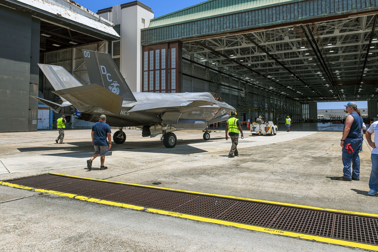 JACKSONVILLE, Fla. (Aug. 08, 2024) Personnel from Fleet Readiness Center Southeast (FRCSE) tow an F-35B Lightning II that was recently delivered from Marine Fighter Attack Squadron 122 at Yuma, Ariz. The jet is the first F-35 ever inducted into the depot and is part of a readiness improvement initiative to support corrosion mitigation efforts for the U.S. Marine Corps (USMC). (U.S. Navy photo by Toiete Jackson/Released)