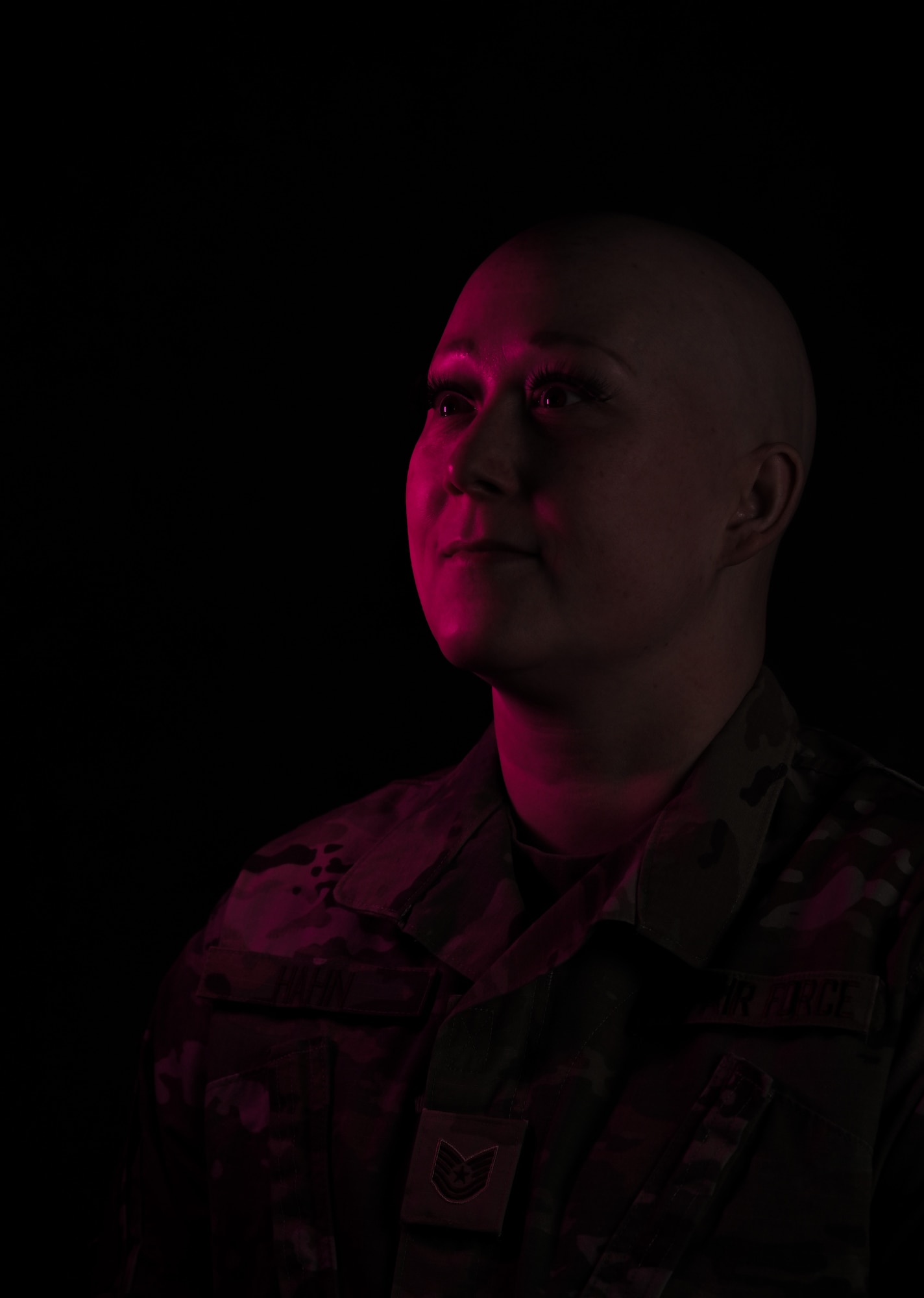 Tech. Sgt. Brandee Hahn, 5th Security Forces Squadron Combat Arms and 5 SFS Armory section chief, poses for a photo supporting breast cancer awareness at Minot Air Force Base, North Dakota, Dec. 13, 2024. In 2021, Hahn received her diagnosis; Stage 3 breast cancer at the age of 31, last April she was diagnosed with Stage 4 breast cancer and is once again in remission. Since receiving her diagnosis, she’s noticed how going through this experience has made her more understanding, more compassionate and an overall better leader, passionate about helping her Airmen and community. (U.S. Air Force photo by Airman 1st Class Alyssa Bankston)